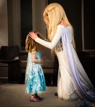 Elsa giving crown to little girl